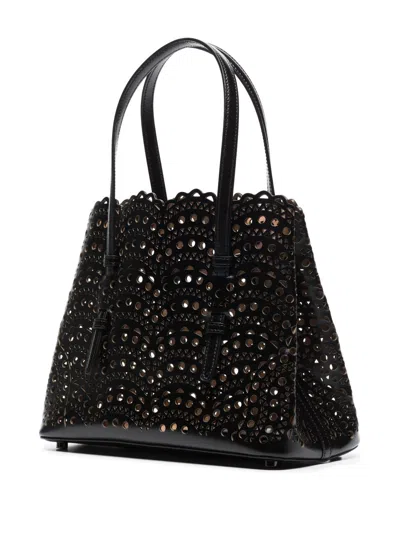 Shop Alaïa Black Cut-out Leather Handbag For Women In Noir