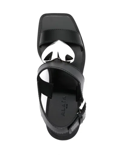 Shop Alaïa Black Leather Sandals With Heart Charm And Block Heel