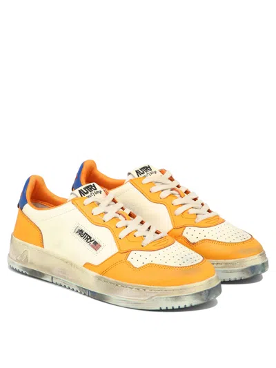 Shop Autry Men's Orange Perforated Sneakers With Vintage Vibe