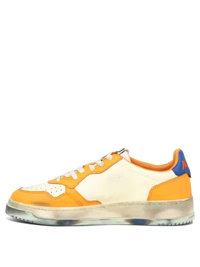 Shop Autry Men's Orange Perforated Sneakers With Vintage Vibe