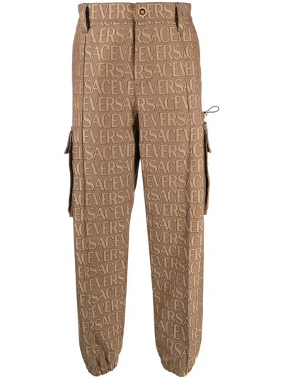 Shop Versace Men's  All-over Motif Cargo Trousers For Fw23 In Brown
