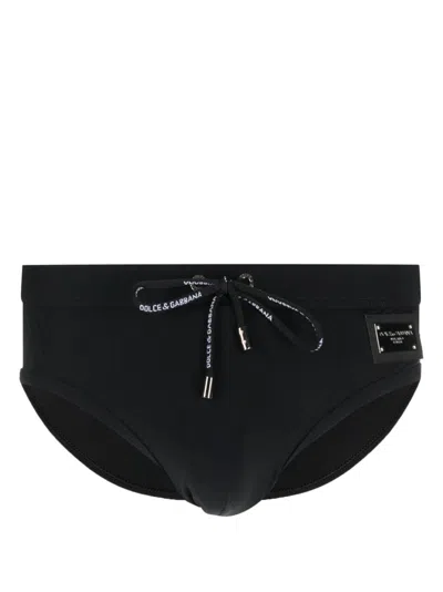 Shop Dolce & Gabbana Bold Logo Plaque Swim Trunks For Men In Black