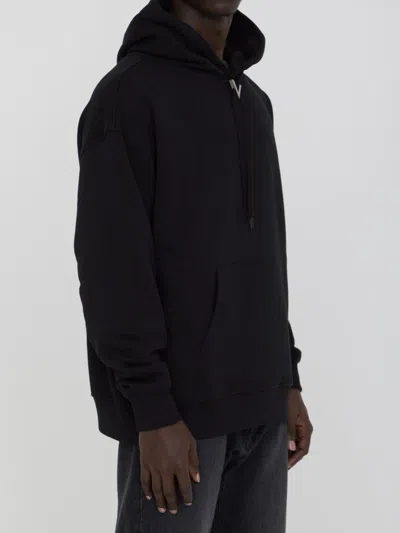 Shop Valentino Hoodie With Metallic V Detail In Black