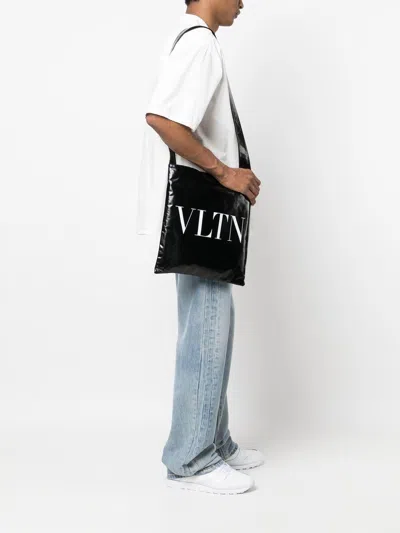 Shop Valentino Black Leather Tote Handbag With Contrasting Vltn Print For Men