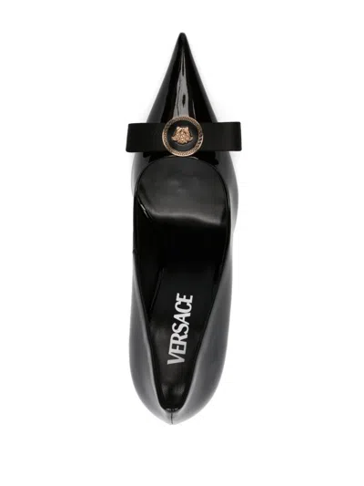 Shop Versace Black Patent Leather Pumps With Medusa Head Motif And Bow Detailing