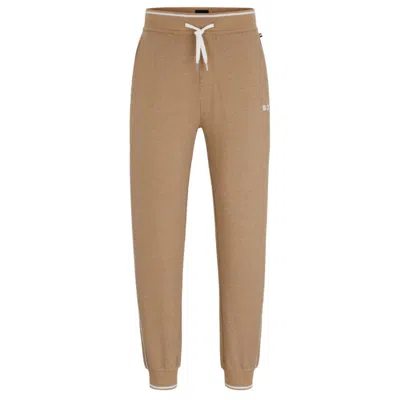 Shop Hugo Boss Piped Tracksuit Bottoms With Embroidered Logo And Drawstring Waist In Beige