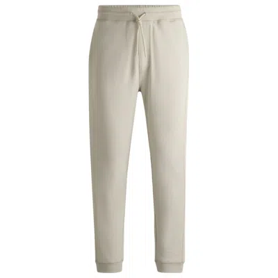 Shop Hugo Boss Cotton-terry Tracksuit Bottoms With Logo Patch In Beige