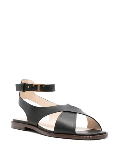 Shop Tod's Black Leather Flat Sandals With Gold-tone Details And Branded Footbed