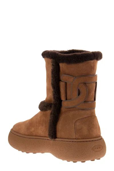 Shop Tod's Chunky Suede Ankle Boot With Iconic Chain Motif And Lamb Fur Lining In Brown