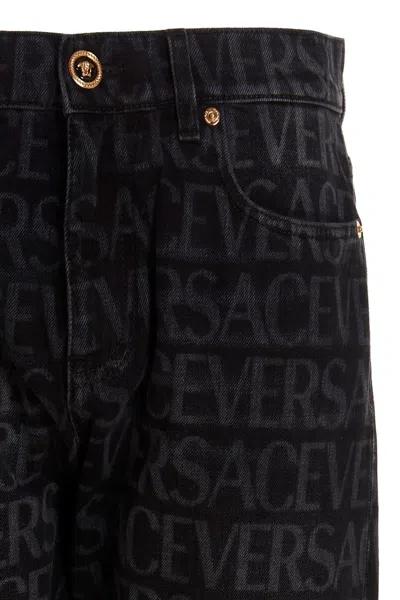 Shop Versace Men Logo Print Jeans In Black