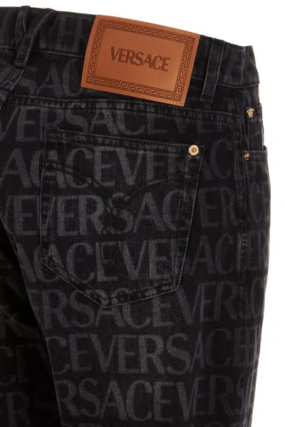 Shop Versace Men Logo Print Jeans In Black