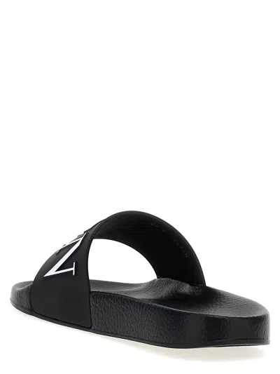 Shop Valentino Garavani  Garavani 'vltn' Slides In White/black