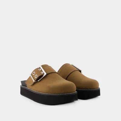 Shop Ganni Feminine Buckle Slides In Brown