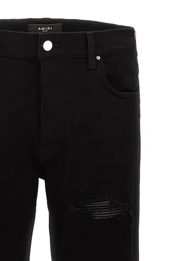 Amiri Slim Fit Distressed Trousers With Rivet Detailing