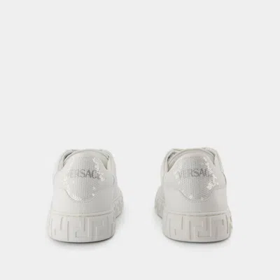 Shop Versace Sneakers In White