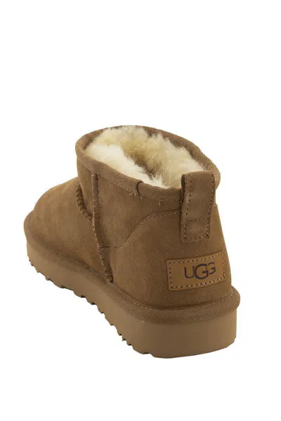 Shop Ugg Classic Ultra Mini - Sheepskin Boot In Brown