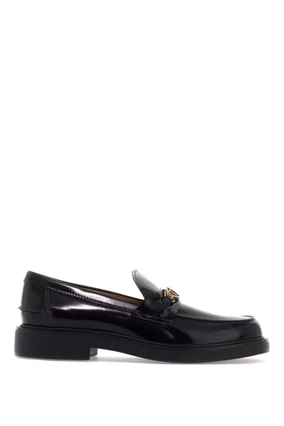 Shop Tod's Metal Logo Loafers With Metal Detailing In Black