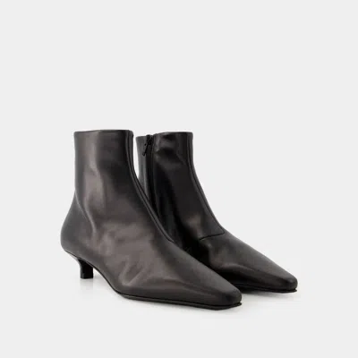 Shop Totême Toteme The Slim Ankle Boots In Black