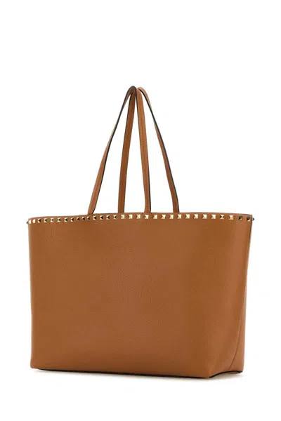 Shop Valentino Garavani Handbags. In Brown