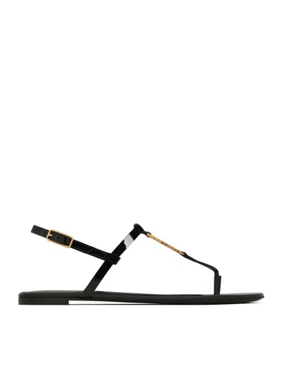 Shop Saint Laurent Cassandra Flat Sandals In Patent Leather With Gold Monogram In Black