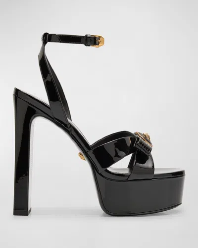 Shop Versace Gianni Patent Bow Platform Sandals In 1b00v-black- Gold