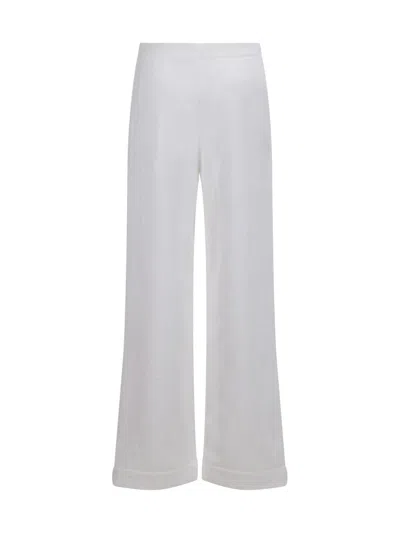 Shop Alaïa Pants In White