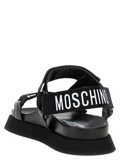 Shop Moschino Sandals In Black