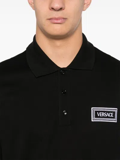 Shop Versace Logo-embroidered Polo Shirt In Black