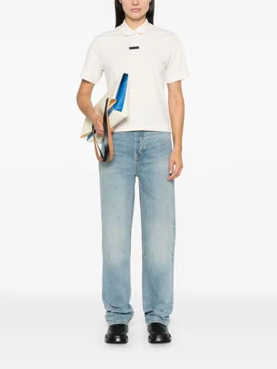 Essentials Embossed Patch Denim Jeans In Blue