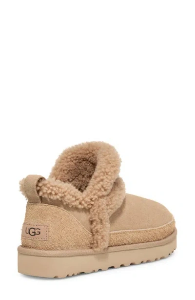 Ugg(r) Classic Ultra Mini Spillseam Genuine Shearling Bootie In Sand