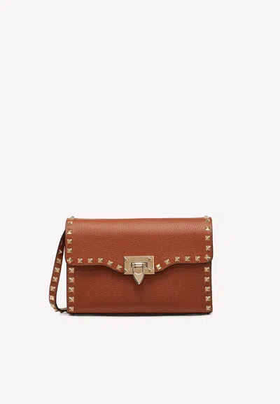 Valentino Small Roman Stud Crossbody Bag In Grained Leather In Brown