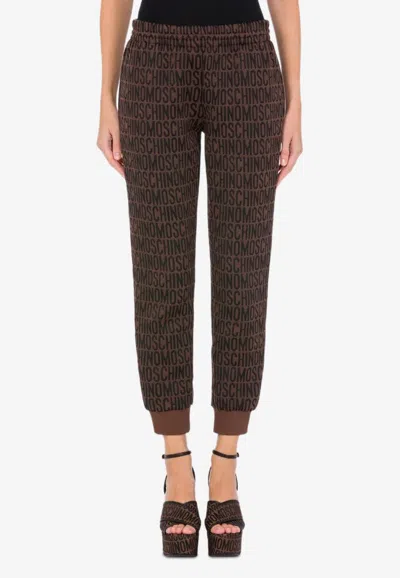 Moschino All-over Jacquard Logo Pants In Brown