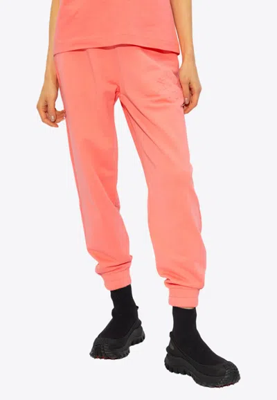 Moncler Embossed Logo Track Pants In Pink