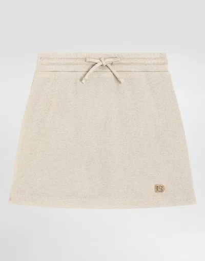 Dolce & Gabbana Lurex Jersey Skirt With Dg Logo In Gold