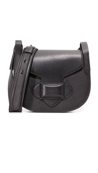 Shop Michael Kors Daria Small Cross Body Saddle Bag In Black
