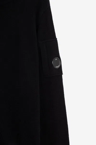 C.p. Company Ribbed Knit Roll Neck Sweater With Signature Lens Detail And Zip Pocket In Black
