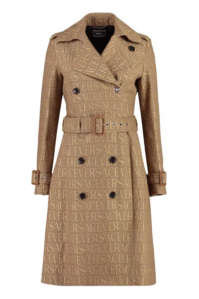 Versace All Over Logo Trench Coat In Beige