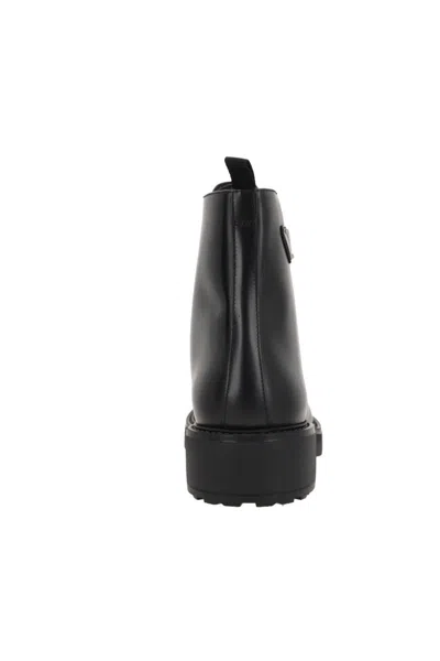 Prada Logo-plaque Panelled Ankle Boots In Black
