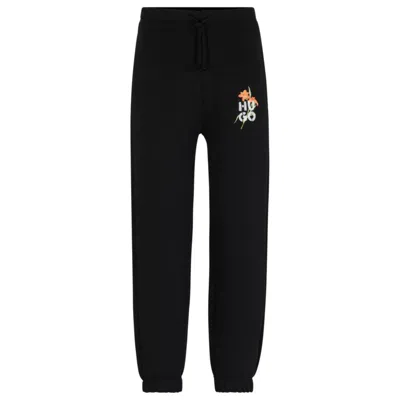 Hugo Boss Relaxed-fit Tracksuit Bottoms With Floral Logo Artwork In Black