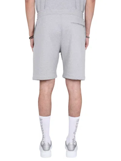 Alexander Mcqueen Men Bermuda Shorts With Graffiti Logo Print In Gray