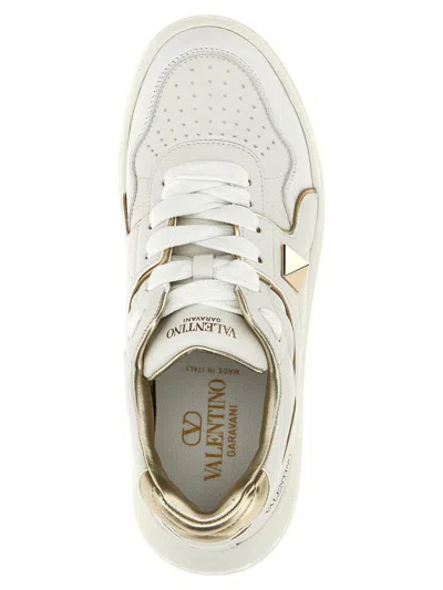 Valentino Perforated Leather Studded Sneakers In Gold