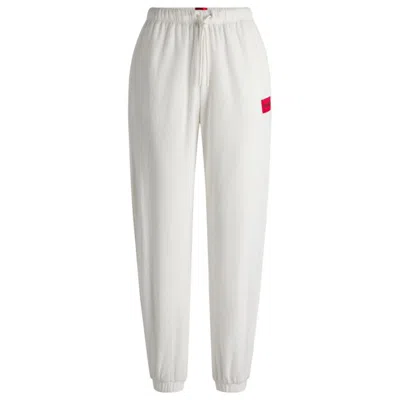 Hugo Boss Tracksuit Bottoms With Red Logo Label In White