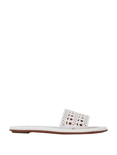 Shop Alaïa Women Mules Flat Traforate In White