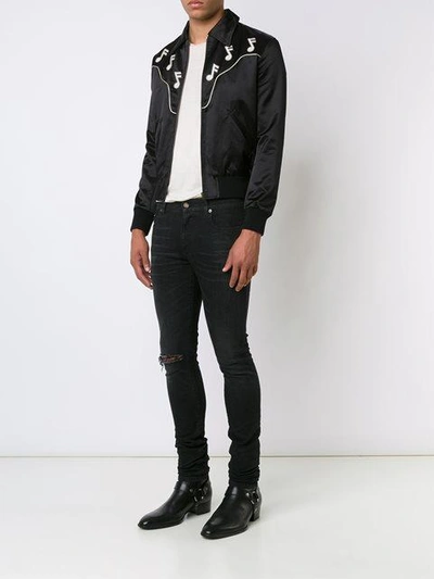 Shop Saint Laurent Distressed Skinny Jeans - Black