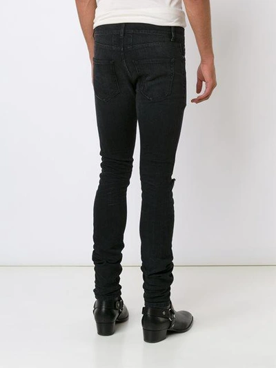 Shop Saint Laurent Distressed Skinny Jeans - Black