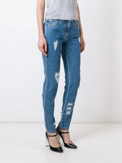 Shop Moschino Distressed Jeans In Blue