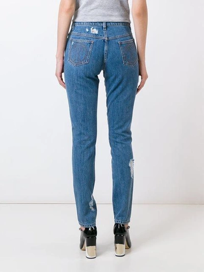 Shop Moschino Distressed Jeans In Blue