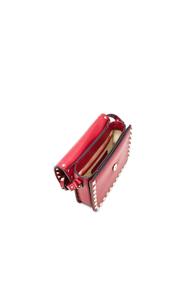 Shop Valentino Rockstud Shoulder Bag In Red