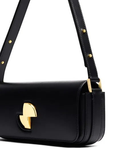 Patou Shoulder Bag With Structured Silhouette And Adjustable Strap In Schwarz