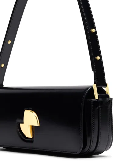 Patou Shoulder Bag With Structured Silhouette And Adjustable Strap In Schwarz